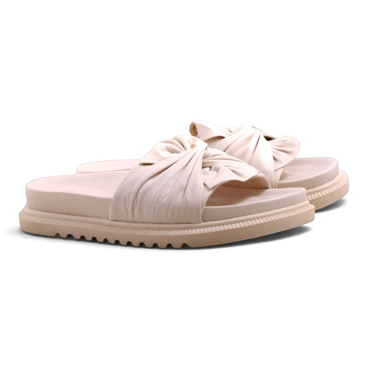 Step Ahead Pesso Borgan cream slide sandals featuring a soft knotted leather strap and a comfortable platform sole.