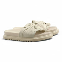Step Ahead Pesso Borgan cream leather slides featuring a knotted strap design and a supportive, textured sole.