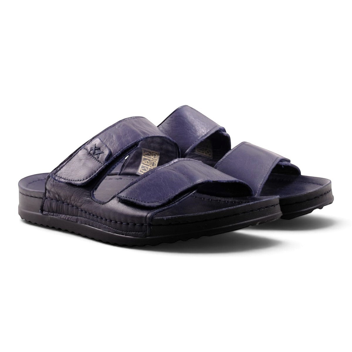 Step Ahead Pesso Sleigh men's navy blue leather slide sandals with adjustable velcro straps and cushioned soles.