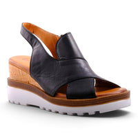 Step Ahead Pesso Well black leather wedge sandals with a cork midsole and white lugged rubber outsole.